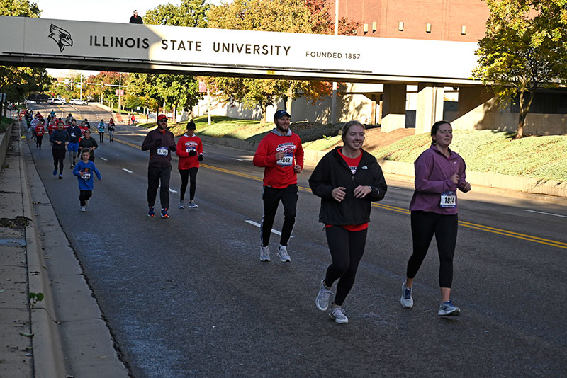 Runners going under ISU bridge.